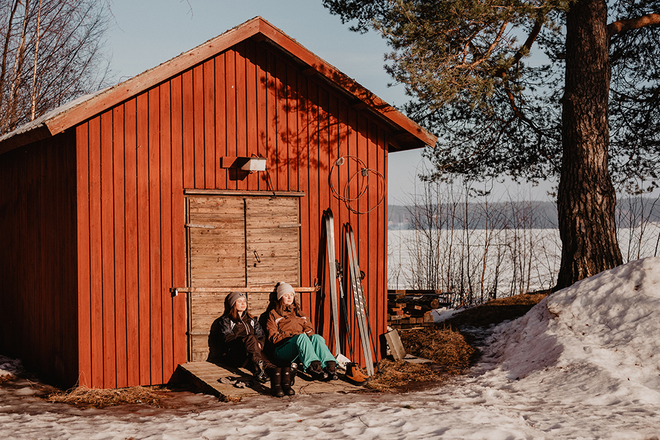 Students hanging out by a cottage